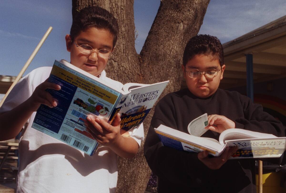 Twins Eddie and Frankie Casteneda,10, both cq) examine new Children's Dictionaries that were given t