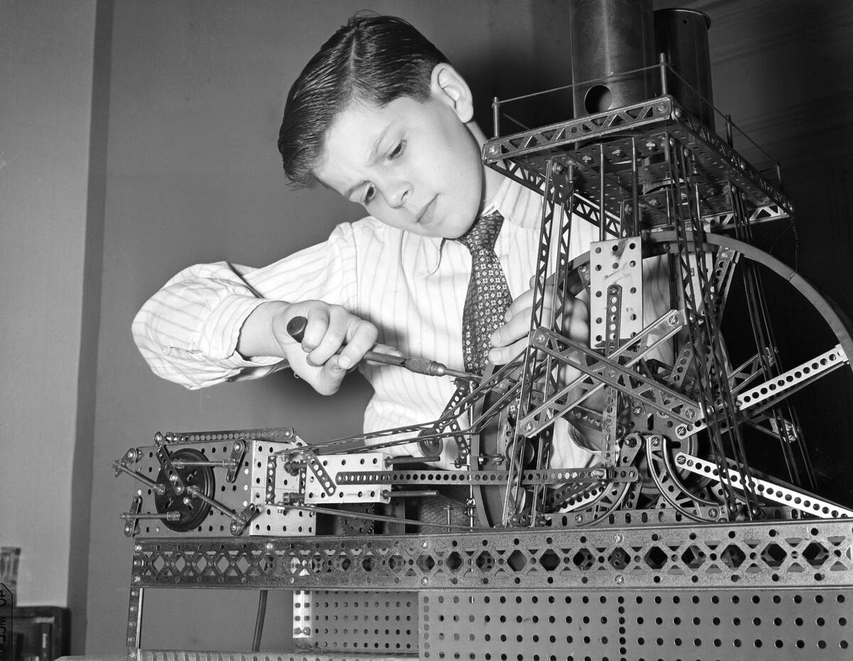 Boy Playing with Mechanical Set