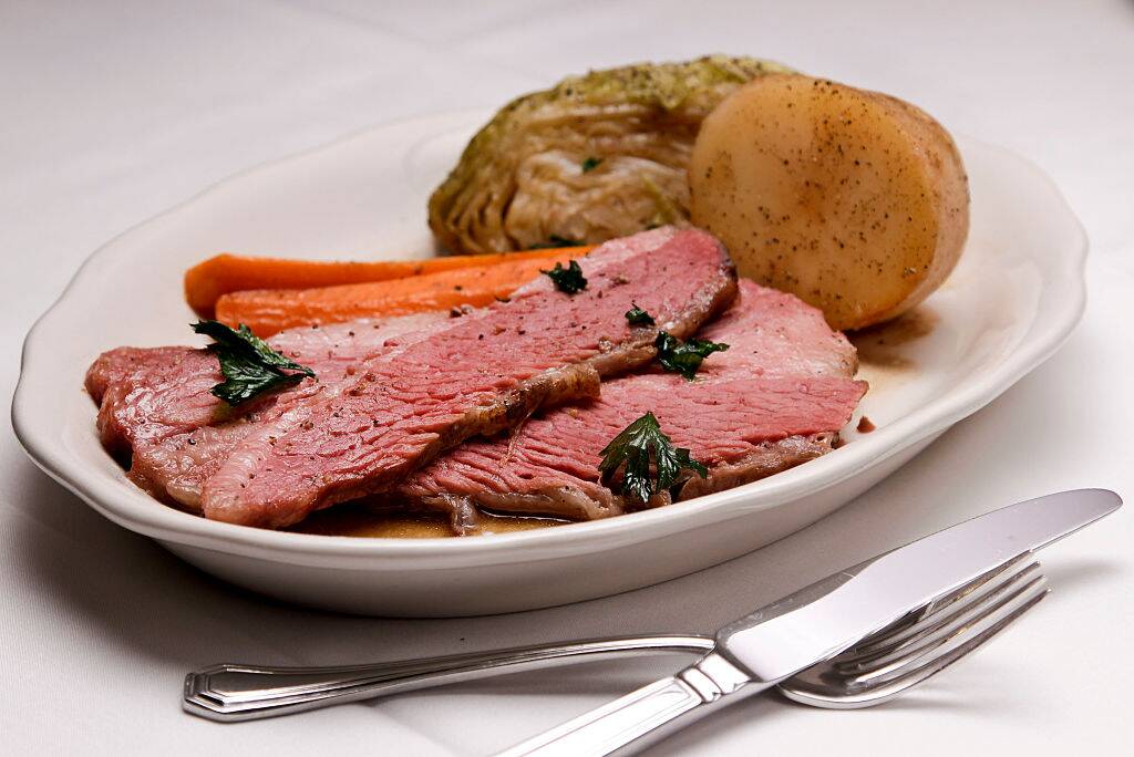 corned beef and cabbage with carrots and a potato