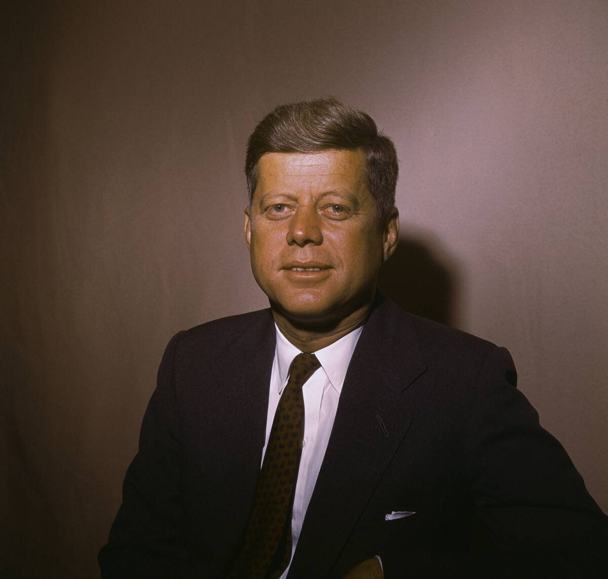 Senator John F. Kennedy Posing by a Wall