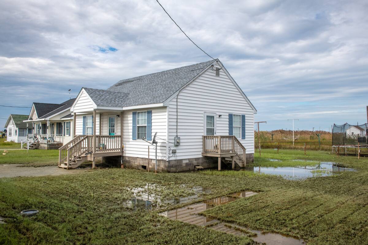 A house on Tangier Island with a flooded yard