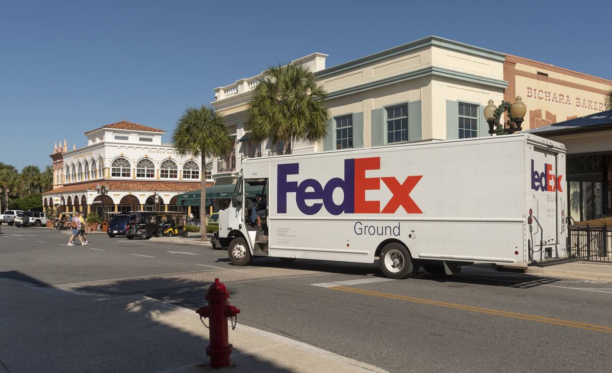 The Villages, Florida, International packet and parcel carrier delivery truck making a stop in a Florida town center.