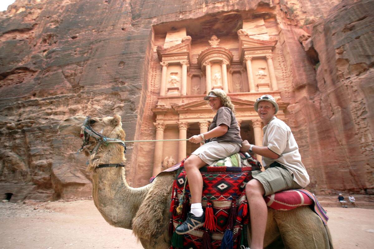 Tourists Ride A Camel In Petra