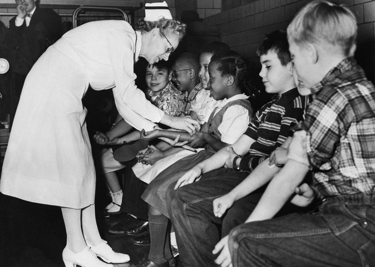 Nurse Preparing Children for Polio Vaccine Shots