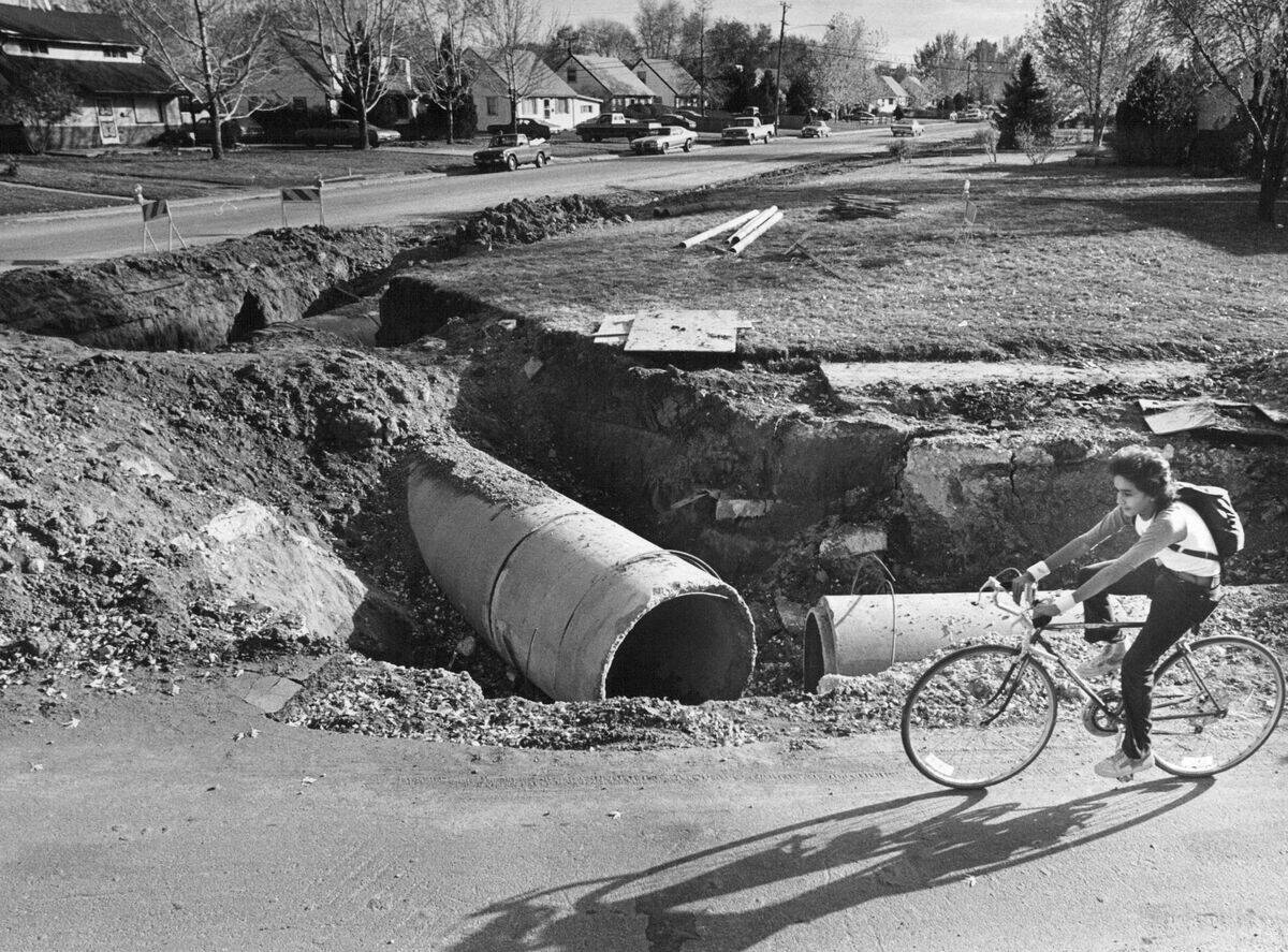 NOV 6 1981, NOV 7 1981; Randy Martinex, 13, of 2590 W. College Ave., pedals past excavation at West