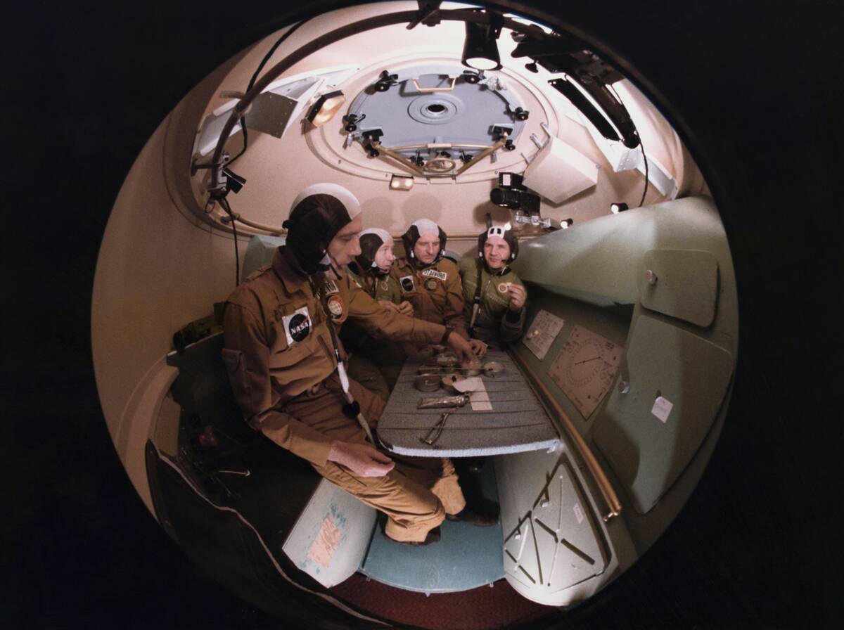 Astronauts and Cosmonauts Having Meal Together