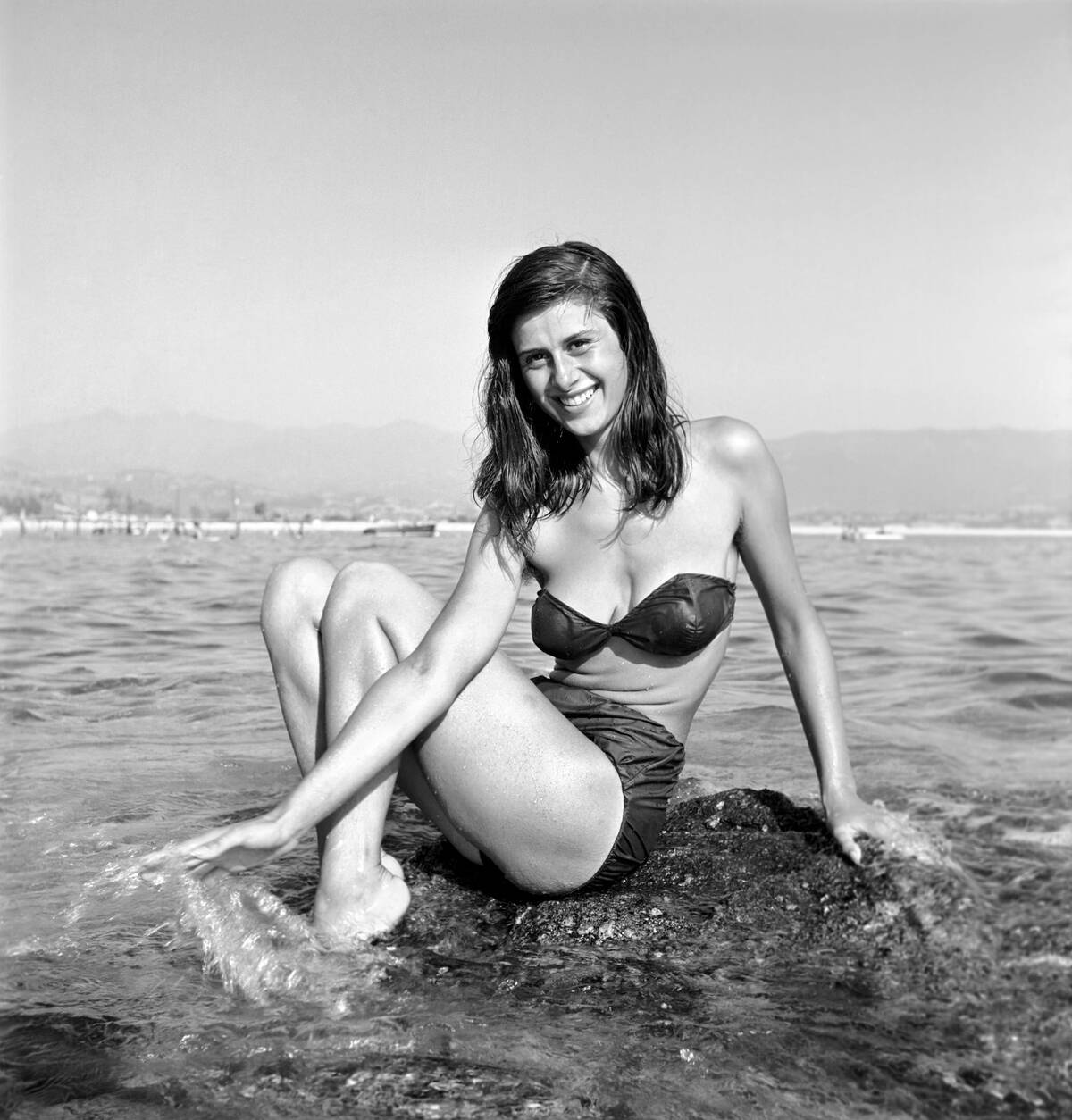 Clothing: Fashion: Beachwear: Holidaymakers: Bathing: Beauties seen here cooling off in the sea in Corsica. August 1957