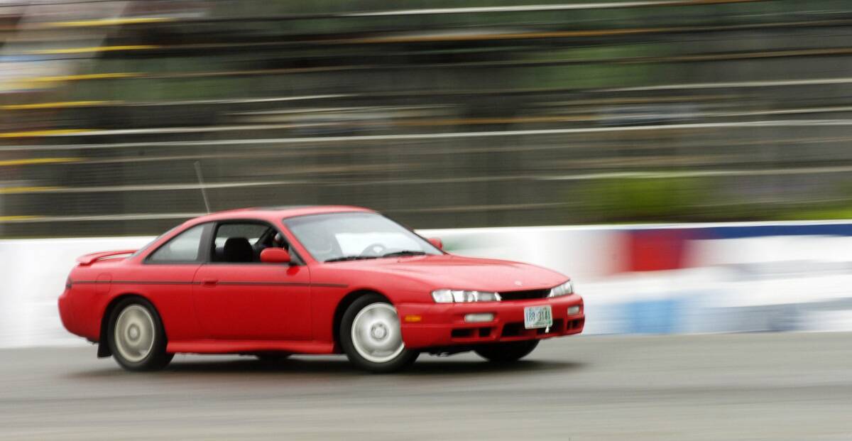 Josh Hebert drifts his 1997 Nissan 240SX through a turn on Beech Ridge Speedway's rain-slicked track...