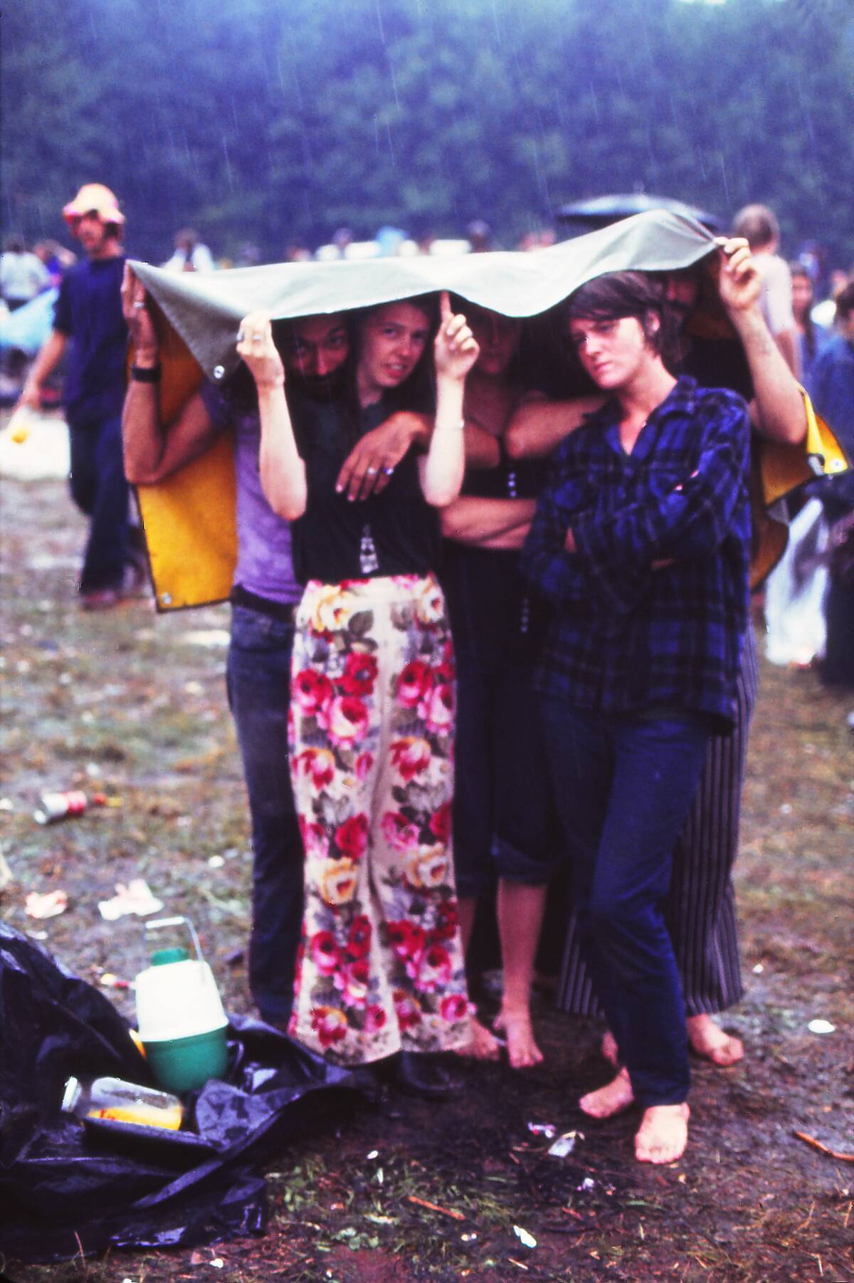People under the rain at the Woodstock Music Festival, 1969