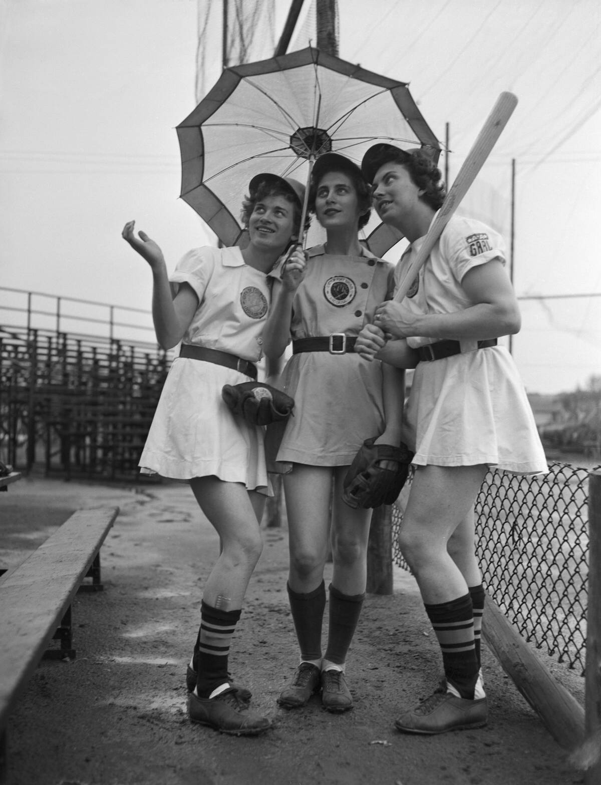 Women in Baseball Uniforms with Umbrella