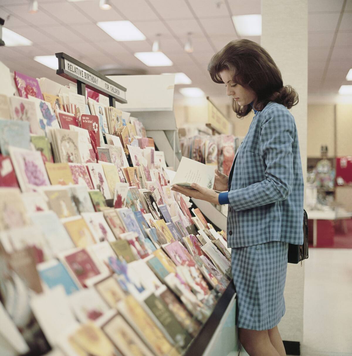 young woman shopping for greeting cards