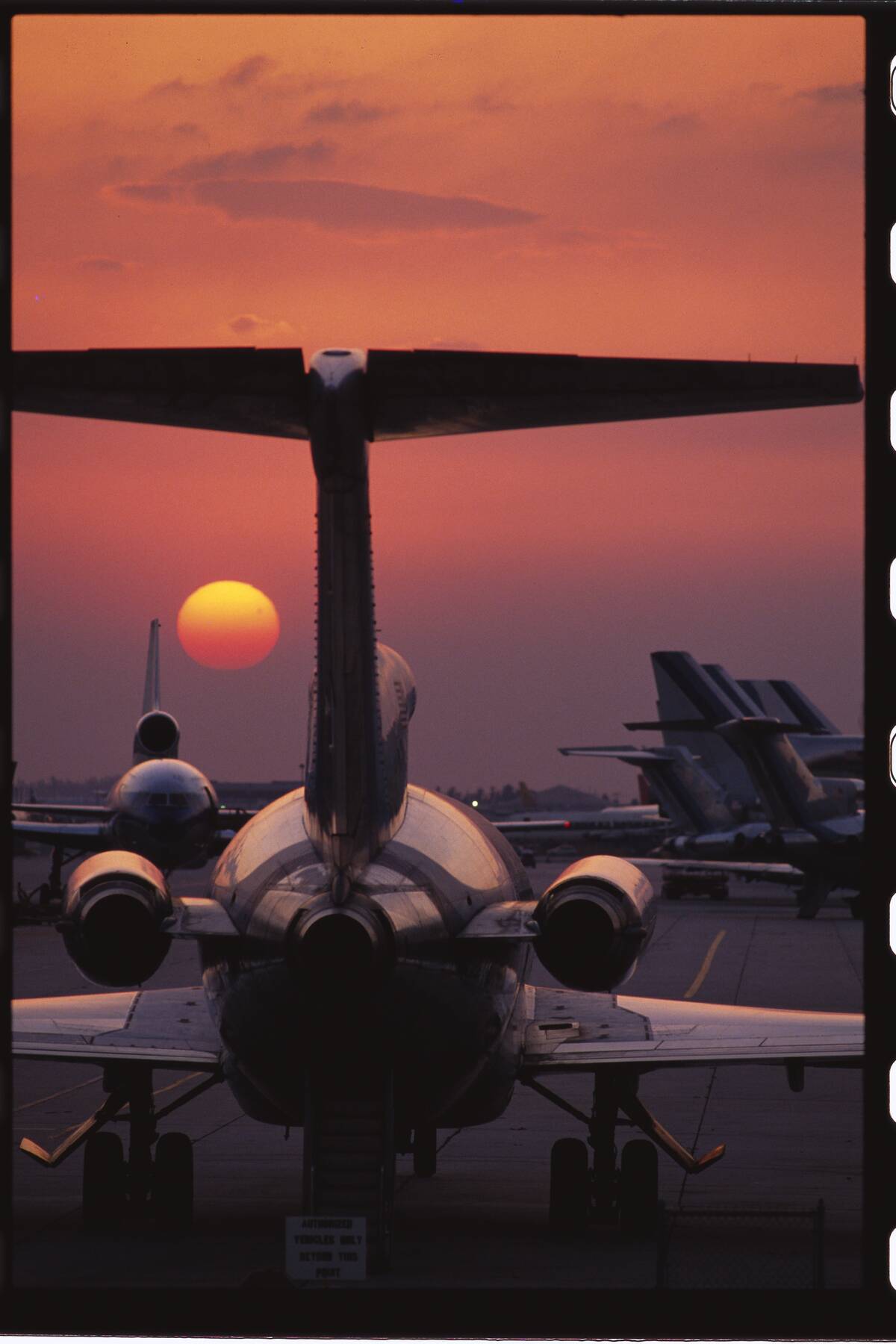 Airplanes on Runway at Sunset
