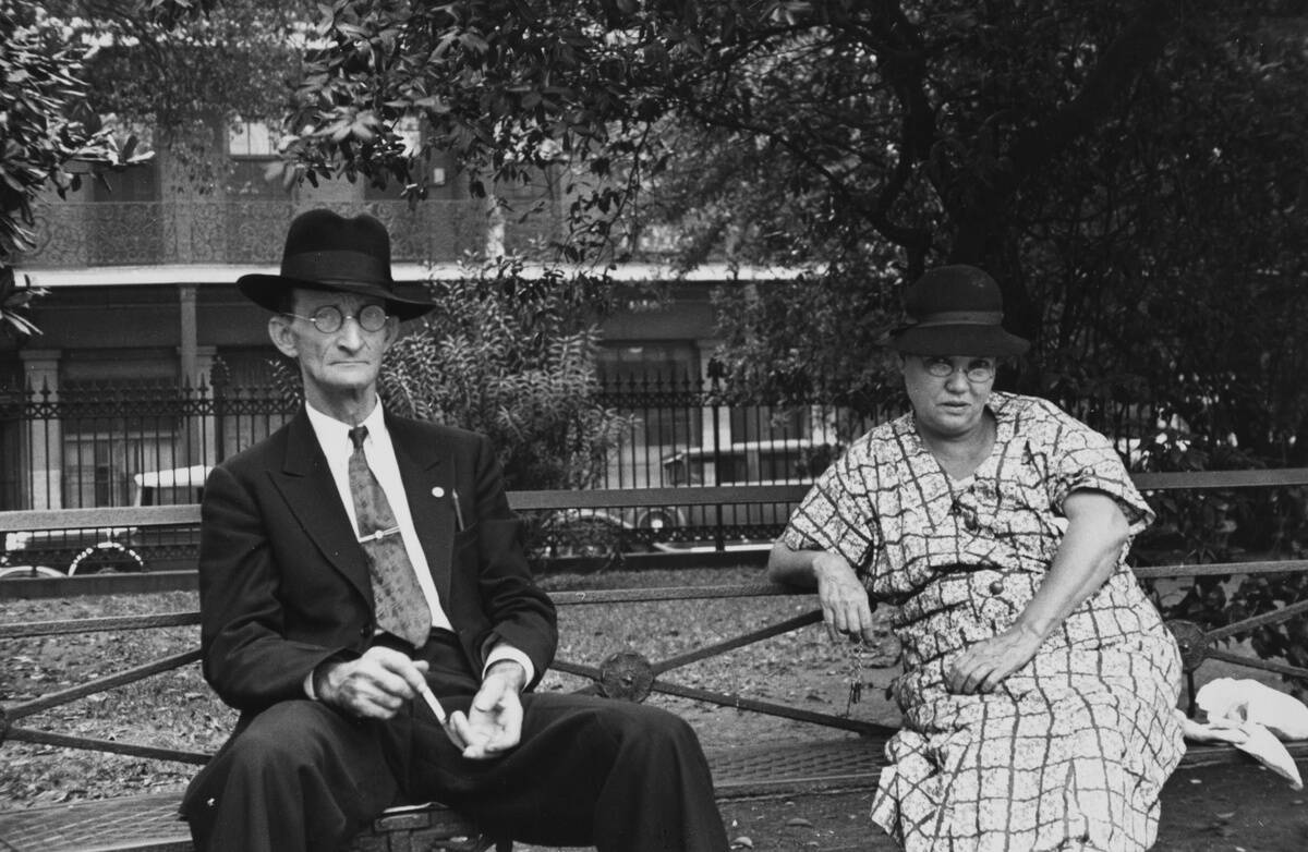 Man And Woman Sitting On Bench