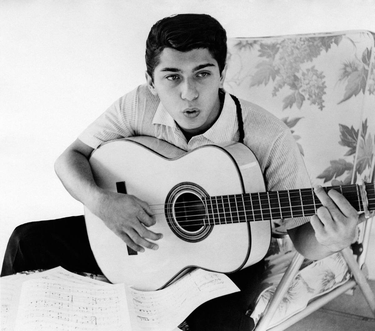 Paul Anka plays a guitar