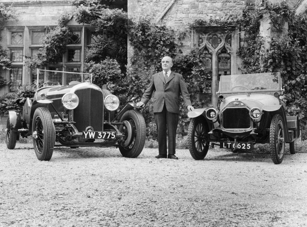 WO Bentley standing between two of his cars.