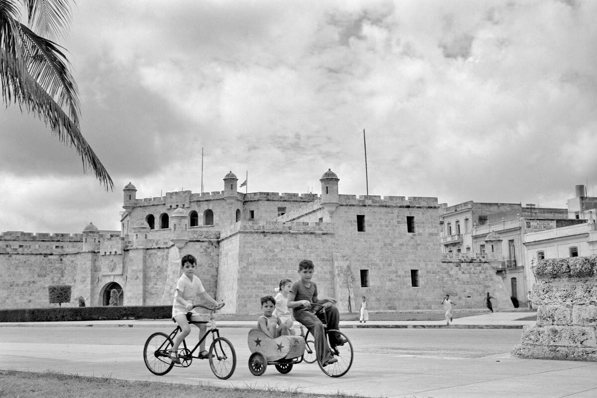 1950s FOUR CHILDREN RIDING...