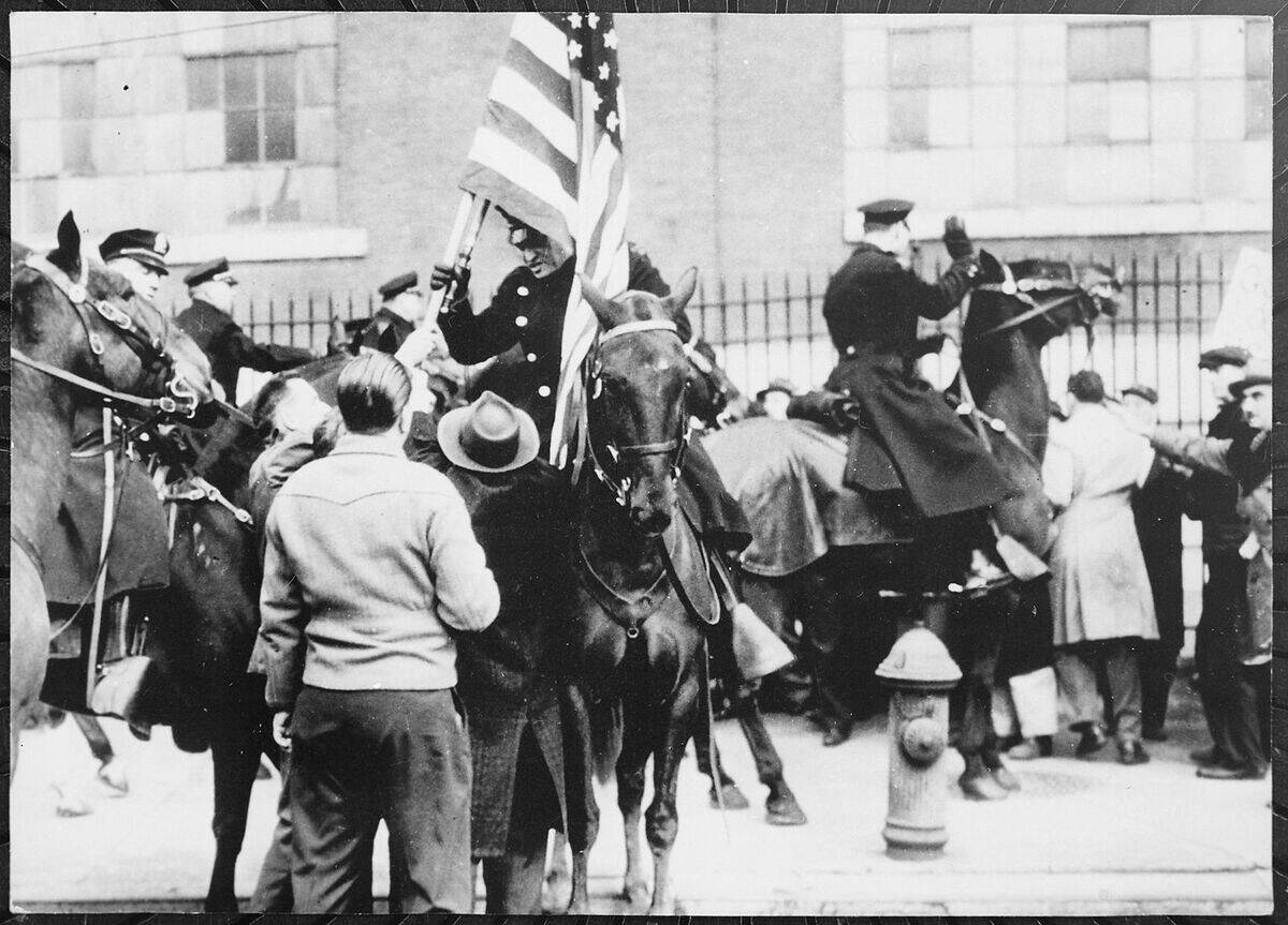 Mounted_police_clashing_with_strikers,_one_carrying_an_American_flag,_outside_an_electrical_plant_in_Philadelphia,_1946_ NARA_-_541924
