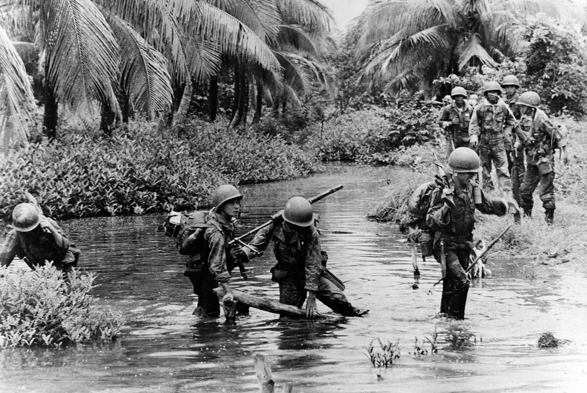 American and South Vietnam soldiers crossing a river during the war...