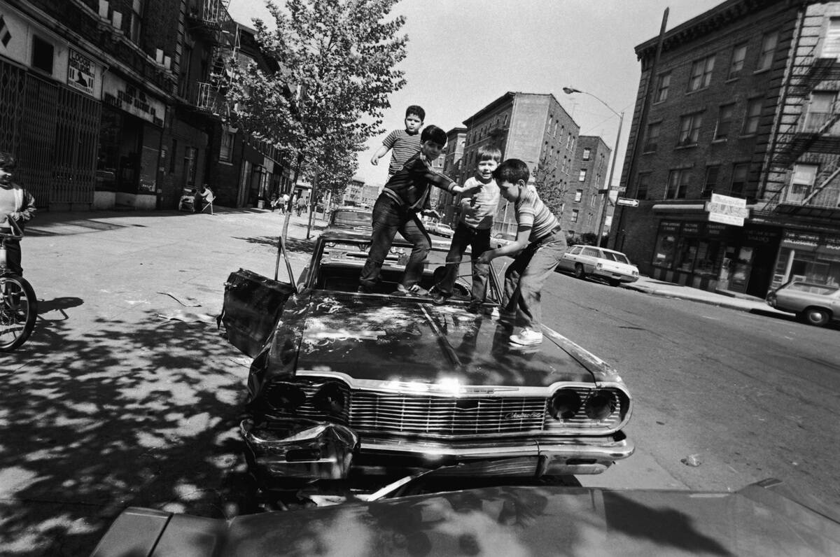 Boys Playing On Abandoned Car Hood