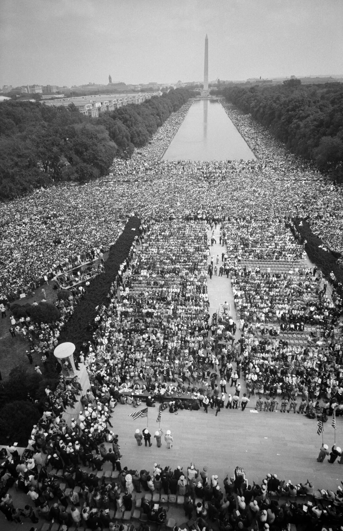 Crowds on The Mall, starting at the Lincoln Memorial, going around the Reflecting Pool, and continuing to the Washington Monument,. USA. 28 August 1963. Photographer: Warren K Leffler.