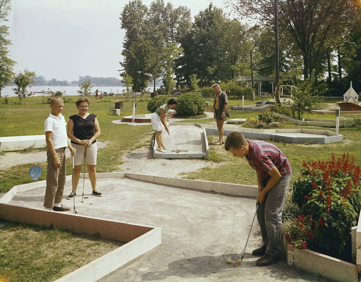 Family Playing Miniature Golf