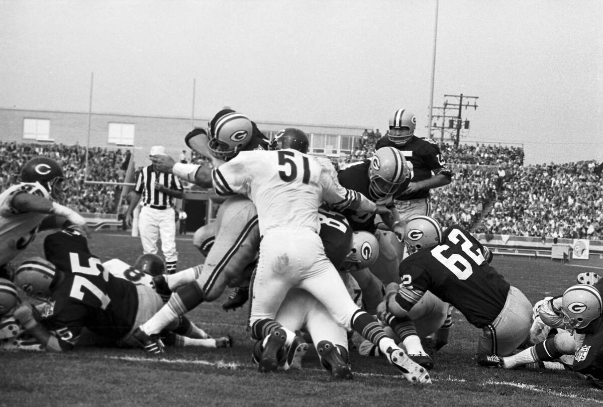 Green Bay Packer Player Being Stopped by Opponents