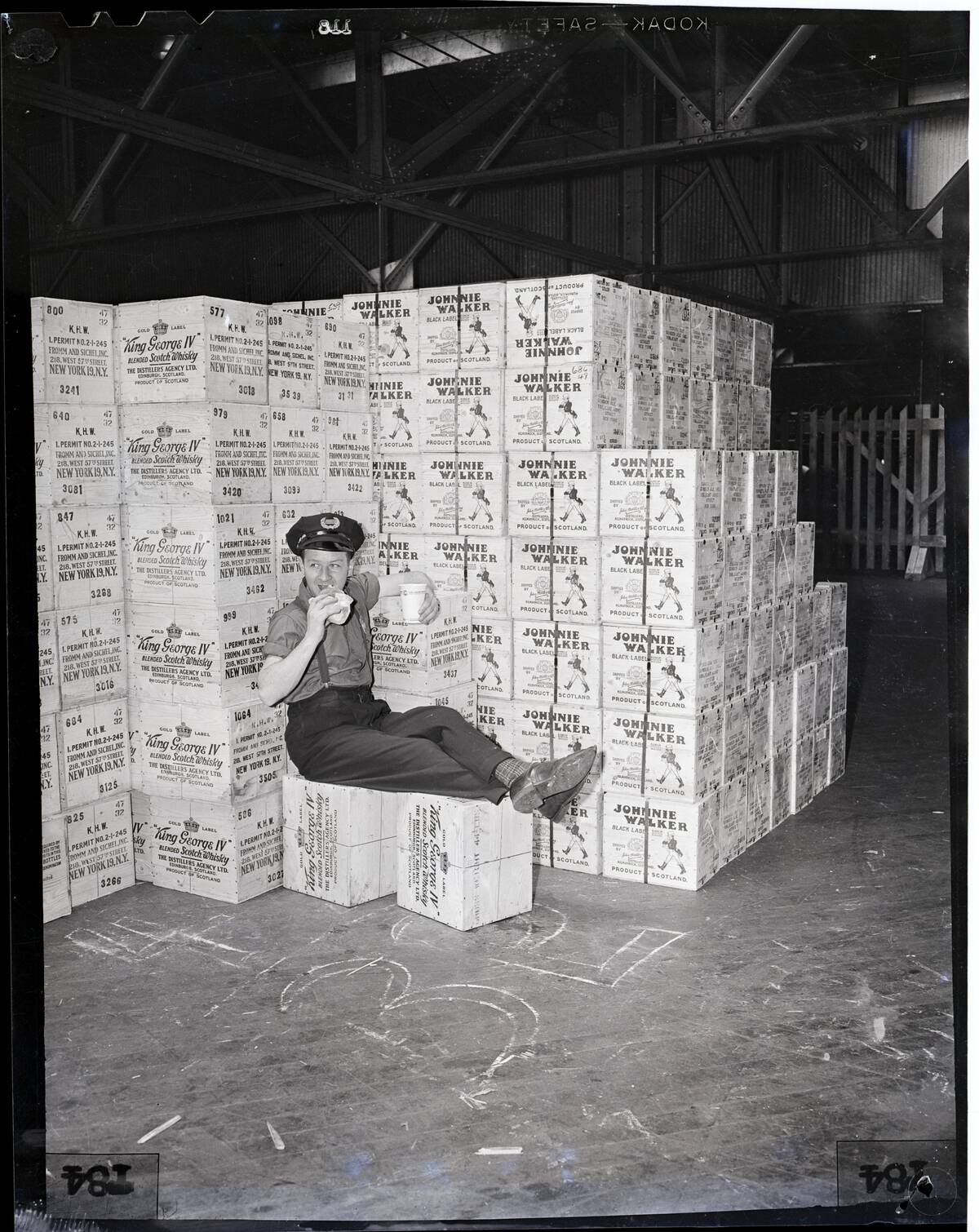 Guard Sits On Cases Of Whiskey