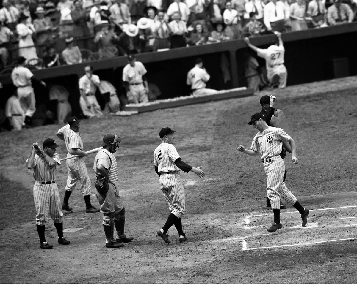Red Rolfe greets Joe DiMaggio after Yankee Clipper belts hom