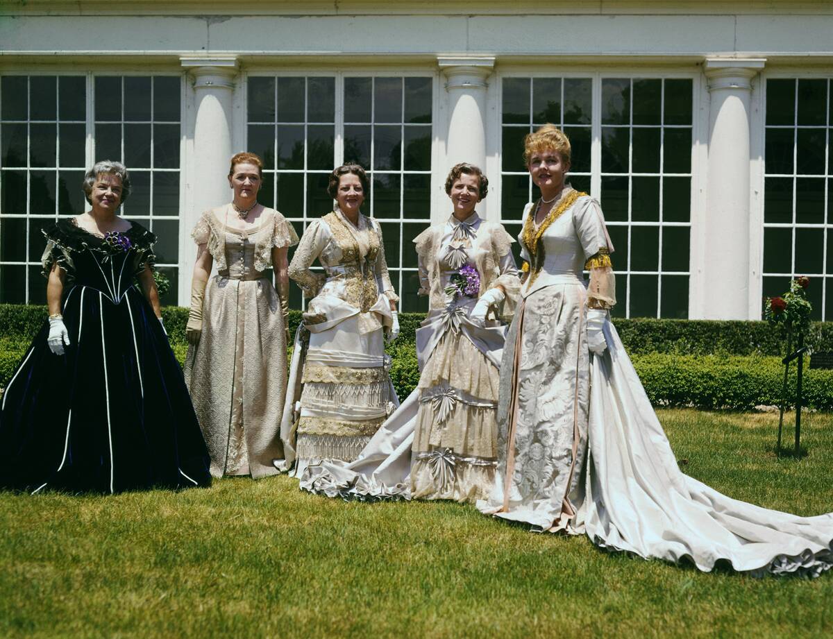 Women Modeling Gowns on Lawn