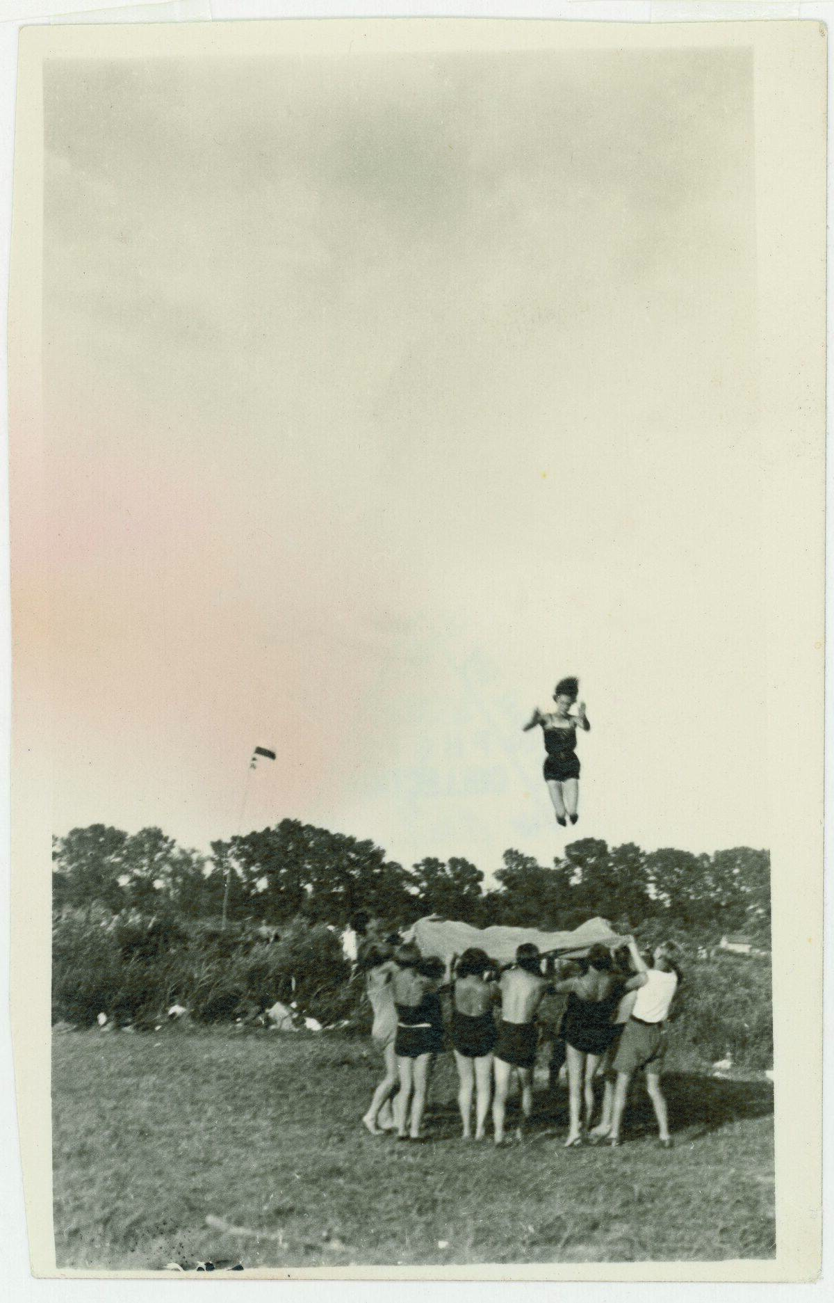 Young woman jumps on a trampoline...