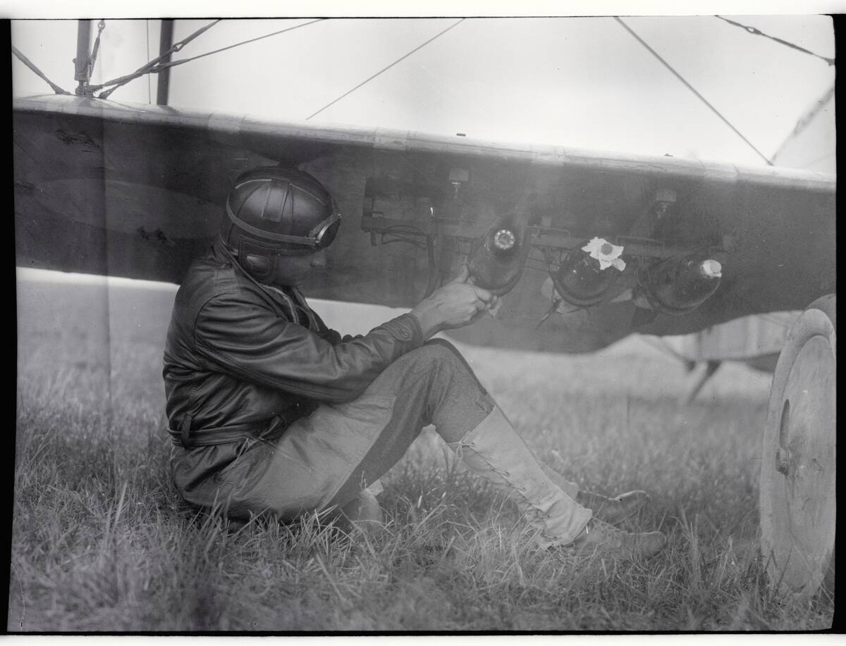 American Pilot Attaching Bombs to Plane