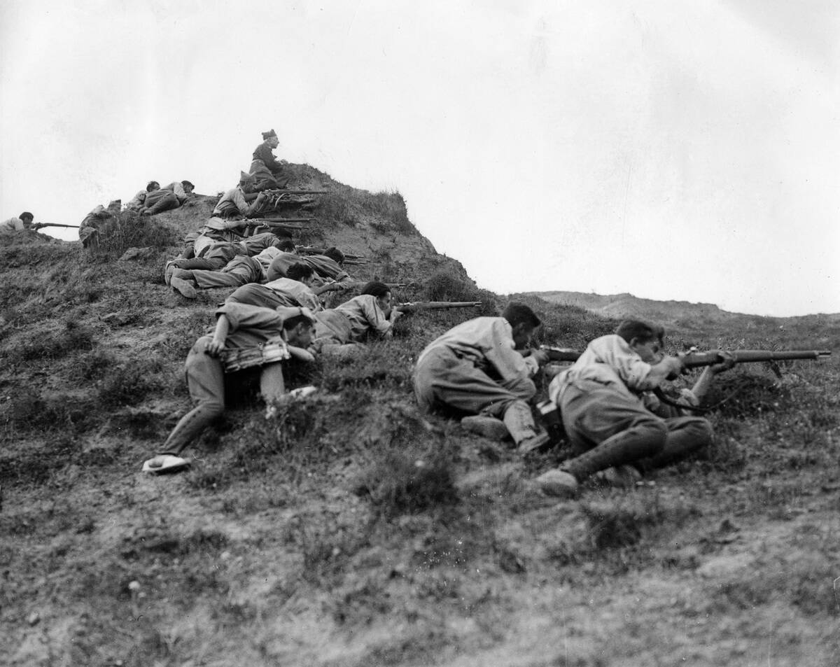 In the great battle for San Sebastian, rebel soldiers take positon on the ridge of the Somosierra Mountainds, overlooking San Sebastian. Madrid. Spain. Photograph. 1936
