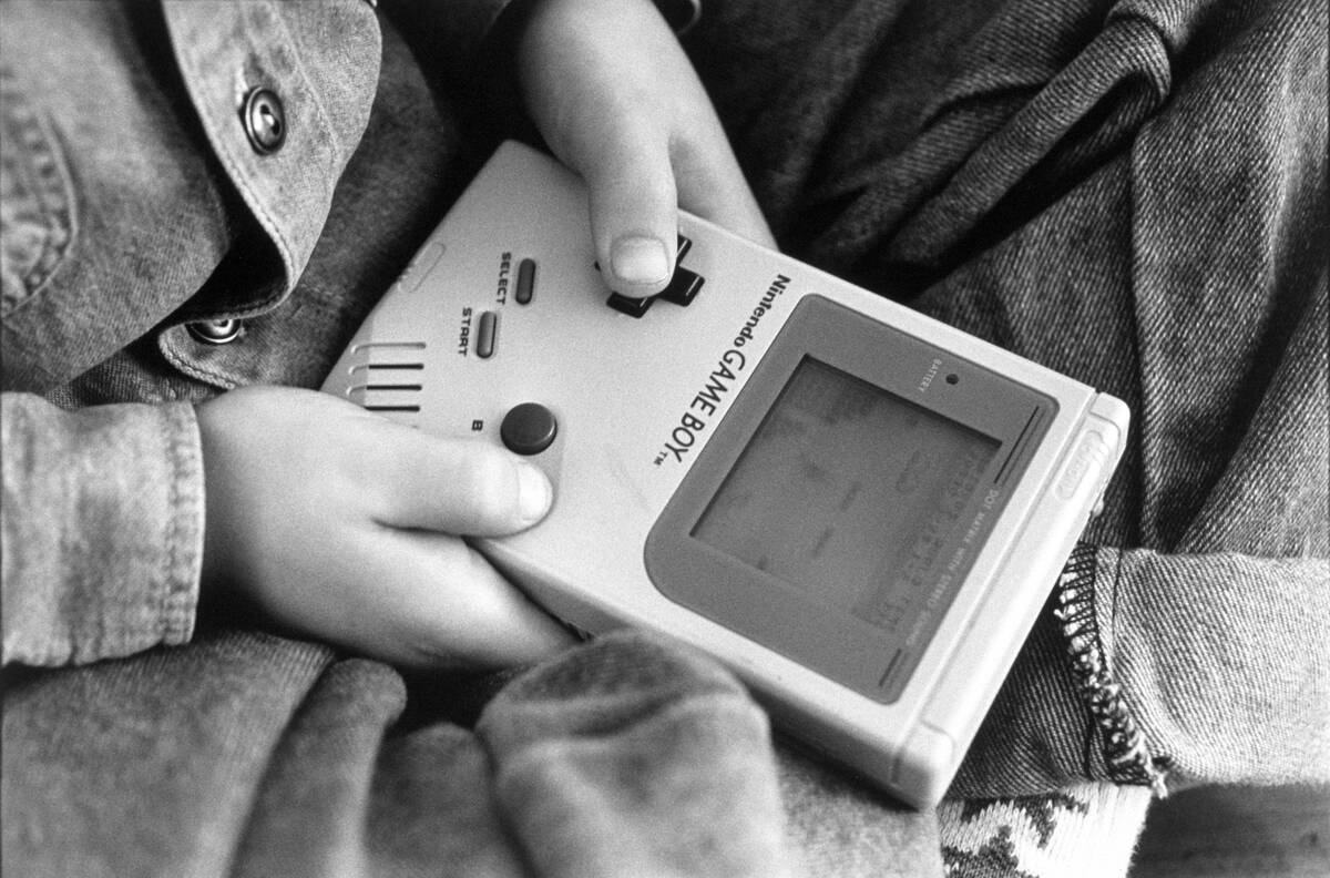 London - A boy playing on one of the first Nintendo Game Boy computers