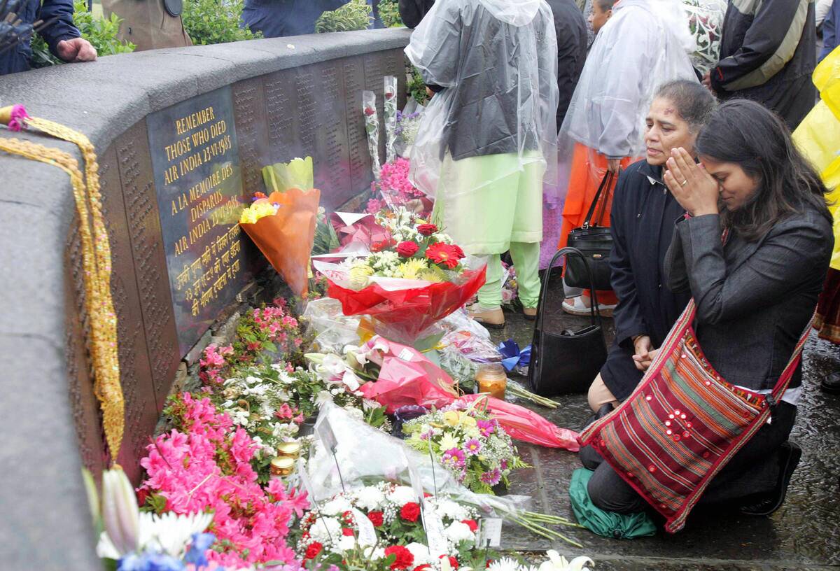 Relatives pray at the Memorial commemora