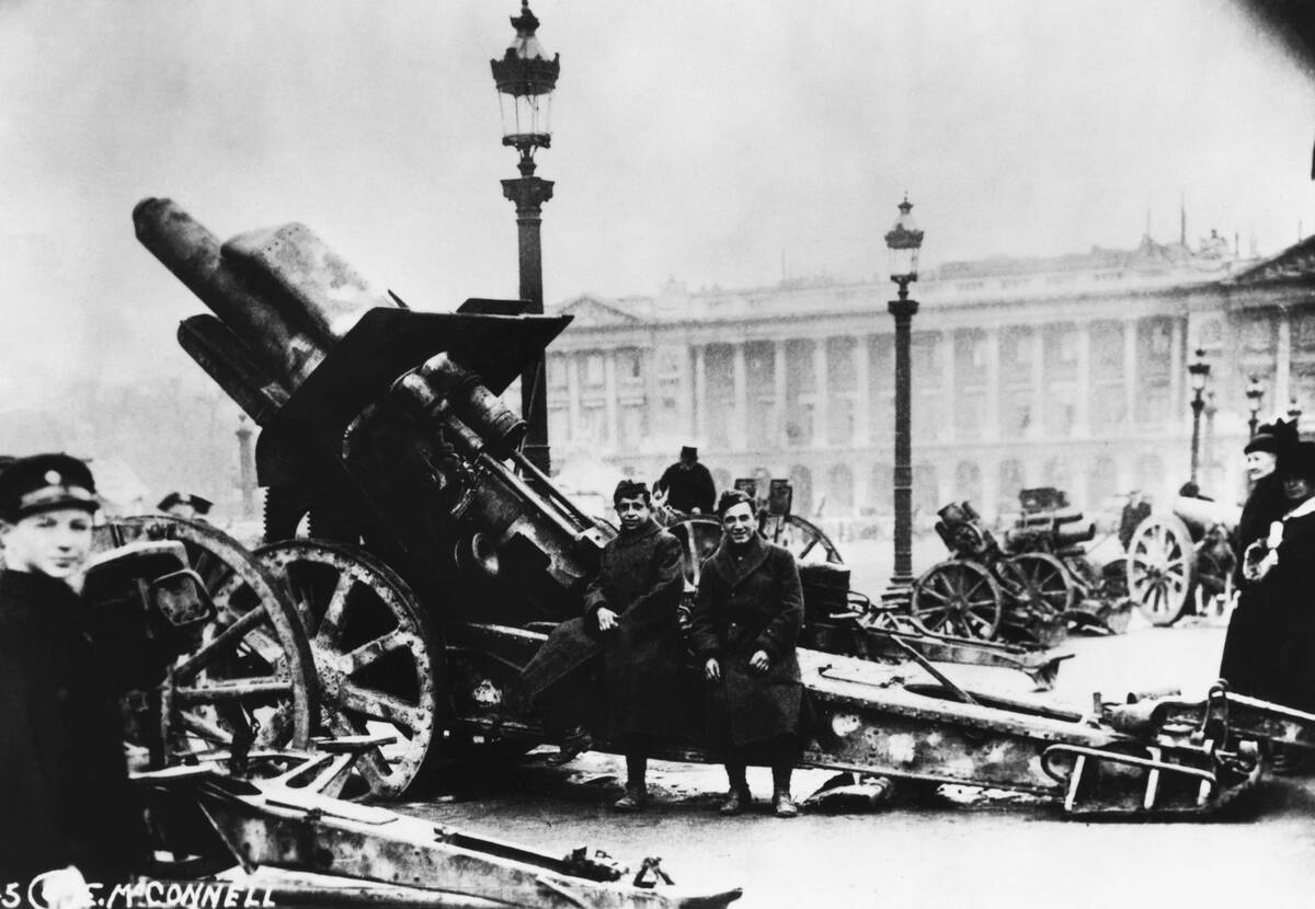 Soldiers Sitting on Big Bertha Artillery Weapon