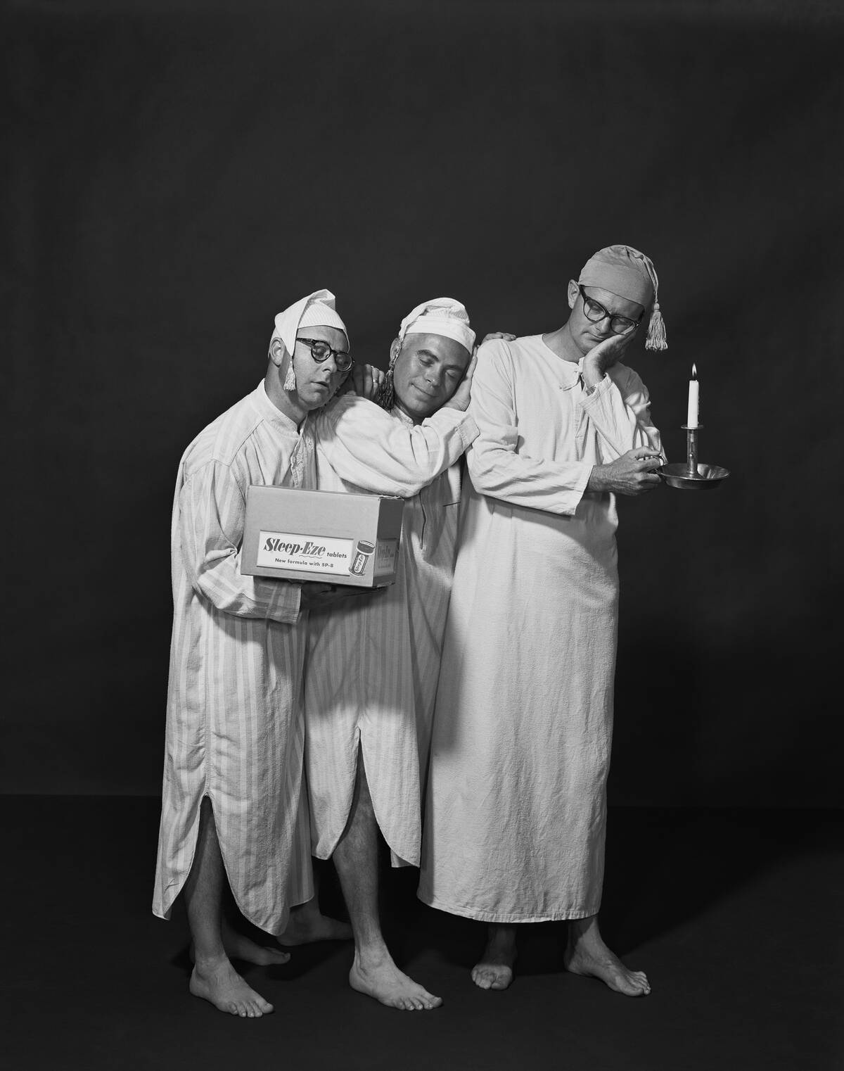Three men sleeping on each other shoulder