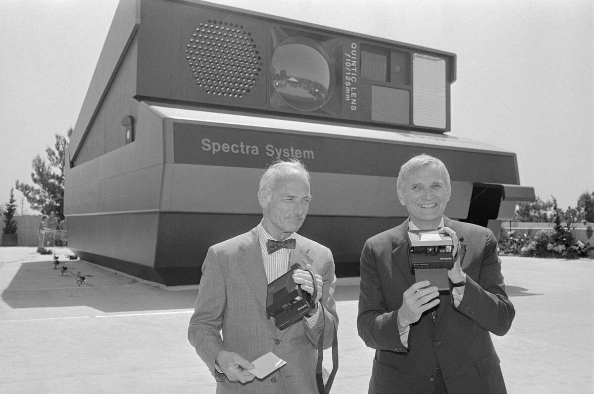 William McCune and MacAllister Booth Holding Camera