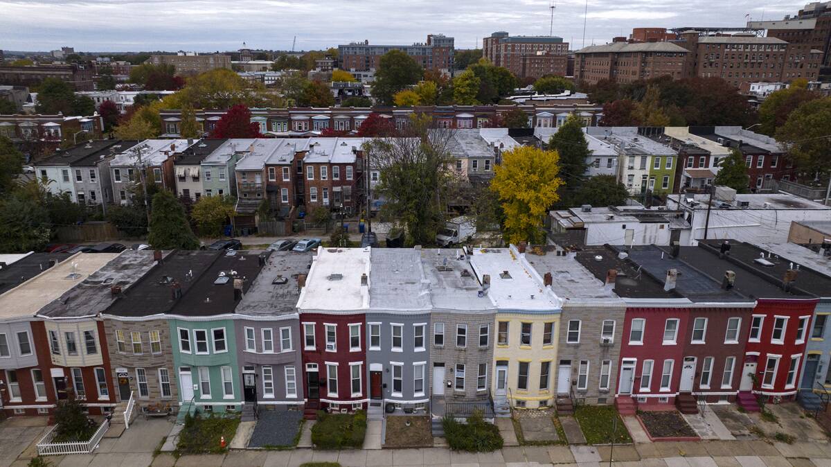 Aerial view of rows of brightly covered row houses of Northern Baltimore