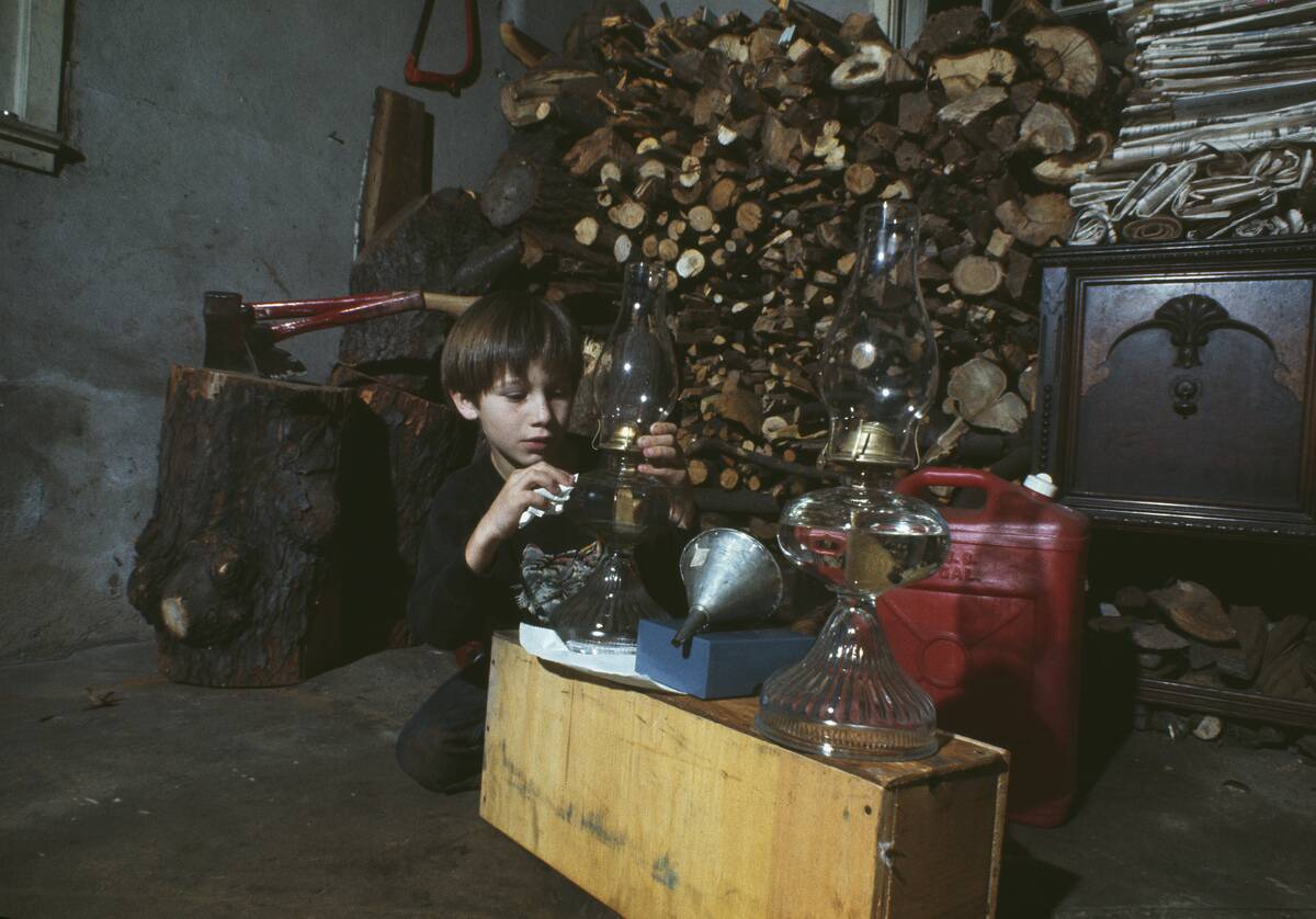 Boy Preparing Oil Lamps