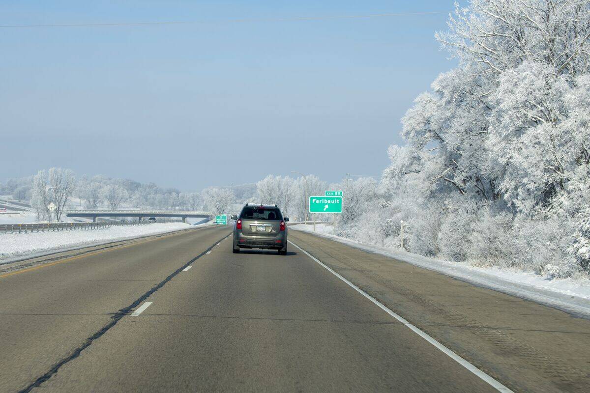 Car going down Interstate 35 after a fresh snowfall