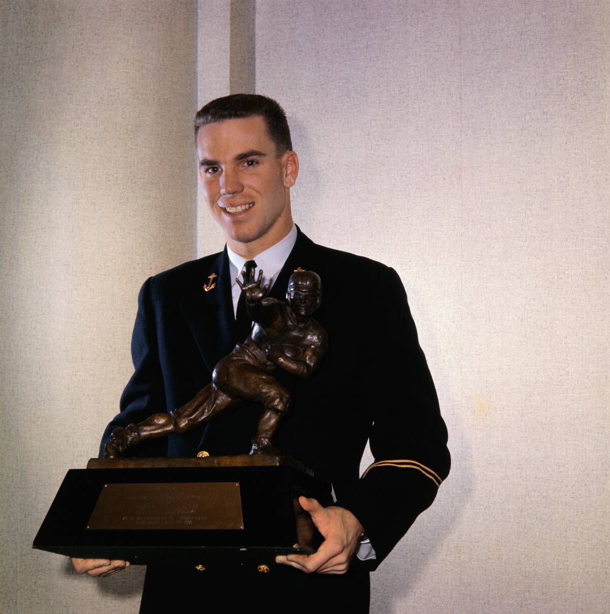 Roger Staubach Holding Heismann Trophy