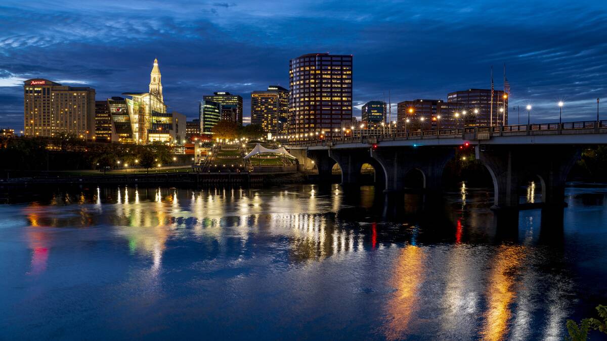 Skyline view of Hartford on Connecticut River with lights coming on, Connecticut