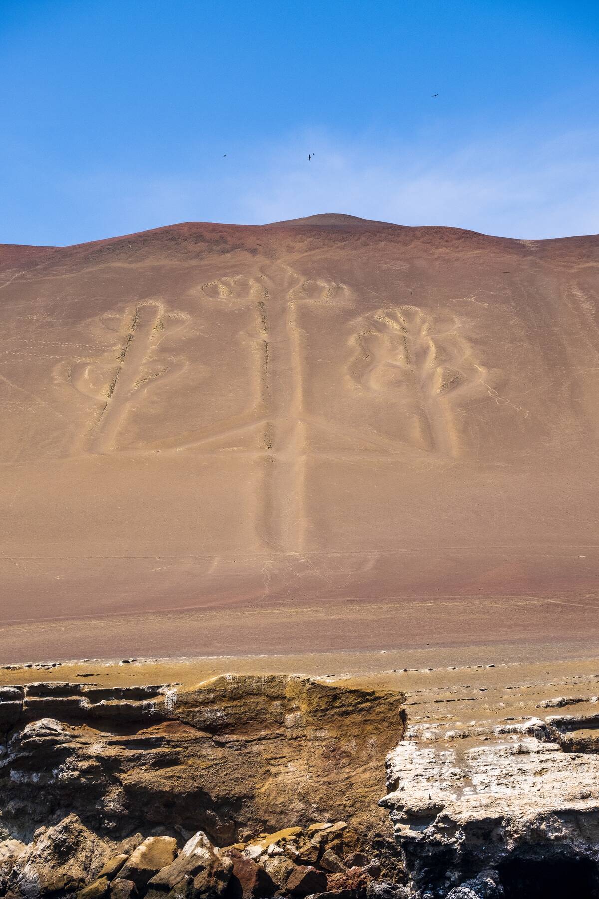 The famous Candelabra lines carved into a hillside facing the sea in Paracas