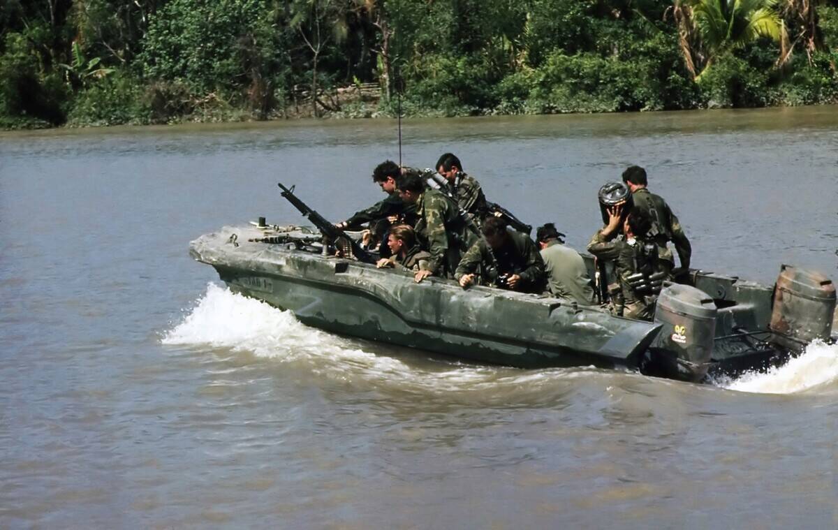 Vietnam: Members of a US Navy SEAL team move down the Hau Giang or Bassac River in a SEAL Team Assault Boat (STAB) near Saigon, November 1967