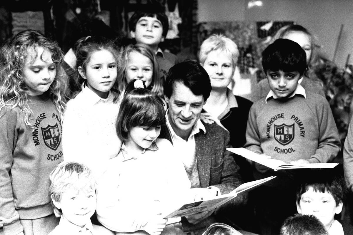 Actor Michael Palin pays a surprise visit to Monkhouse Primary School in North Shields to do a reading session of his new children's books 5 November 1986