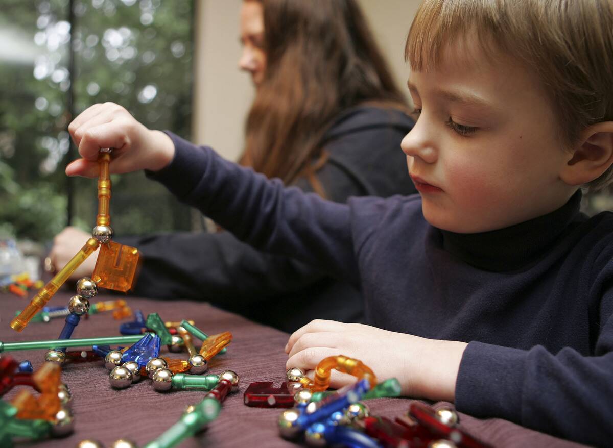 Aidan Thornsberry, 4, shows off his Magnetix toys as mom, Sh