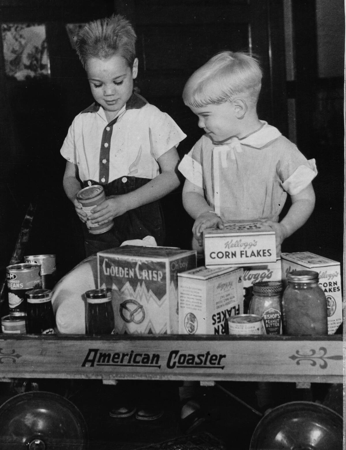 Boys with food-filled toy wagon, 1933