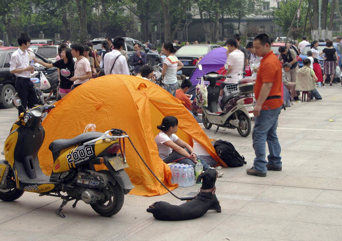 Chinese residents camp out with their do