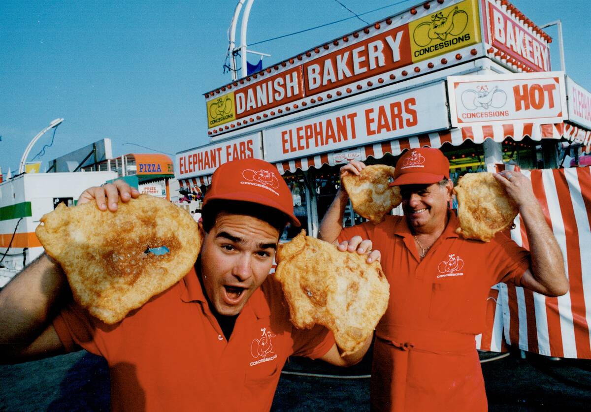 Dough boys: Shaun Fuller; left; and Fred Klemme lend an (elephant) ear outside their booth selling t...