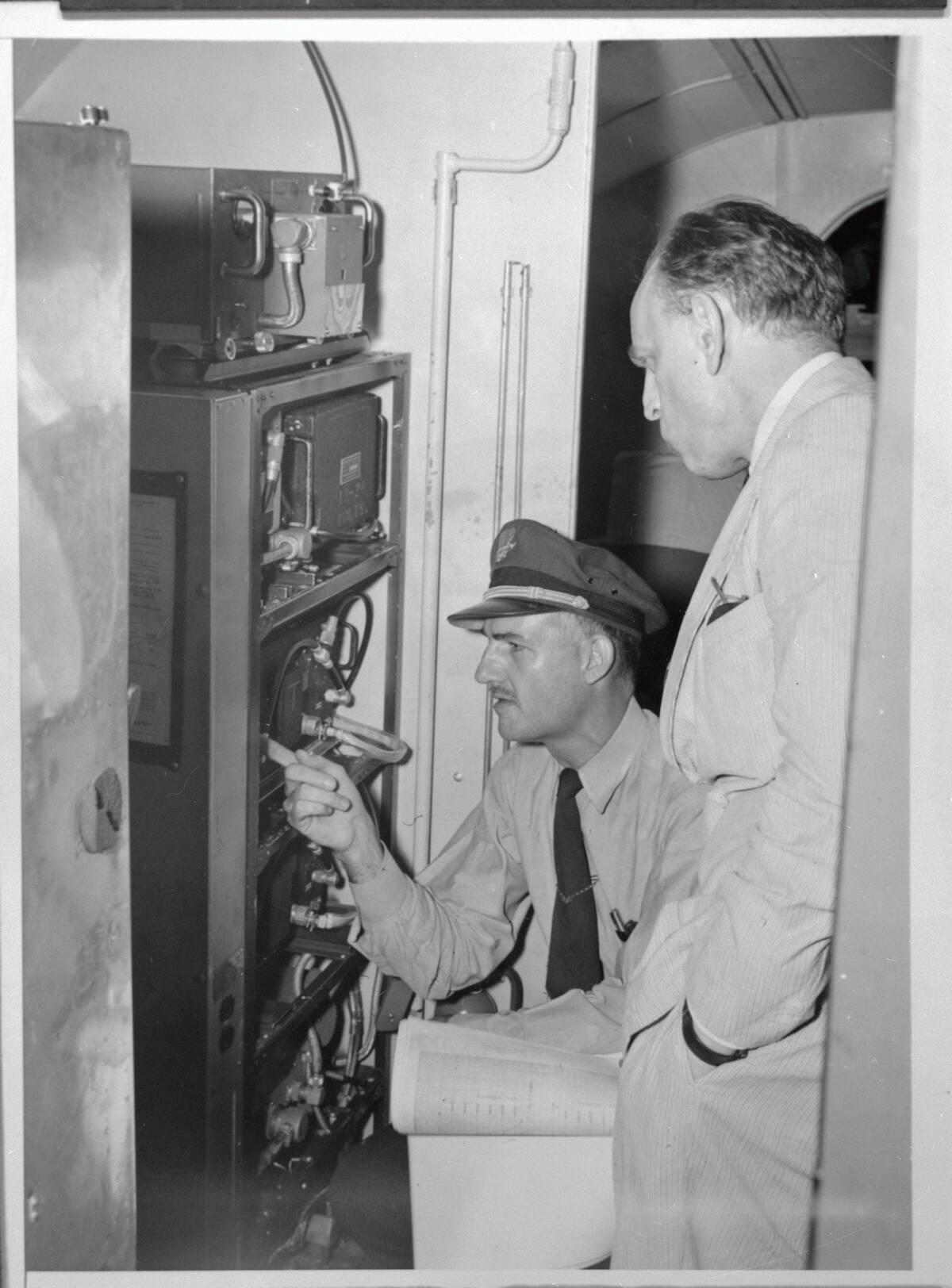Jack Le Claire and James M Landis Inspecting Airplane Radar